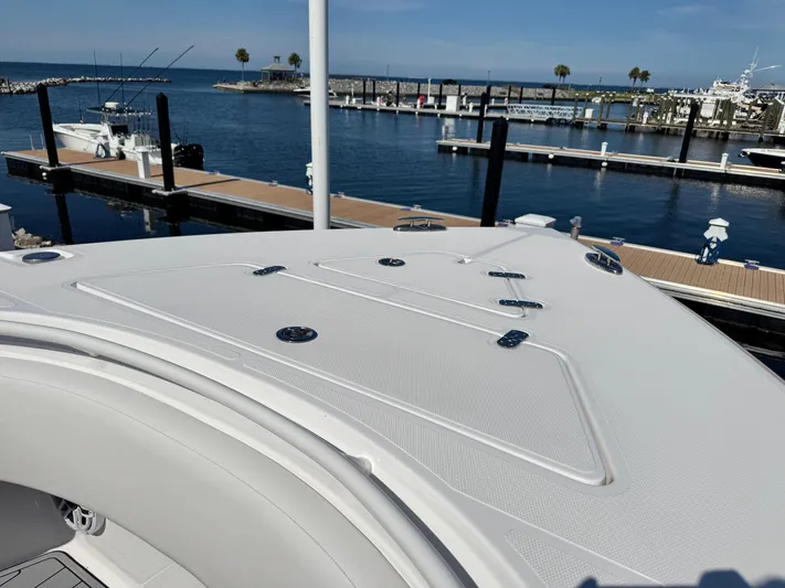  Yacht Photos Pics 2025 Fountain 34 TE boat docked at marina, clear blue sky, calm water.