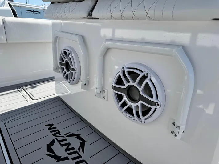  Yacht Photos Pics 2025 Fountain 34 TE boat interior with JL Audio speakers and cushioned seating.