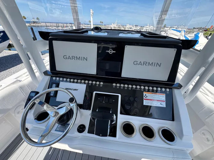  Yacht Photos Pics Control panel of 2025 Fountain 34 TE boat with Garmin displays and Mercury steering wheel.