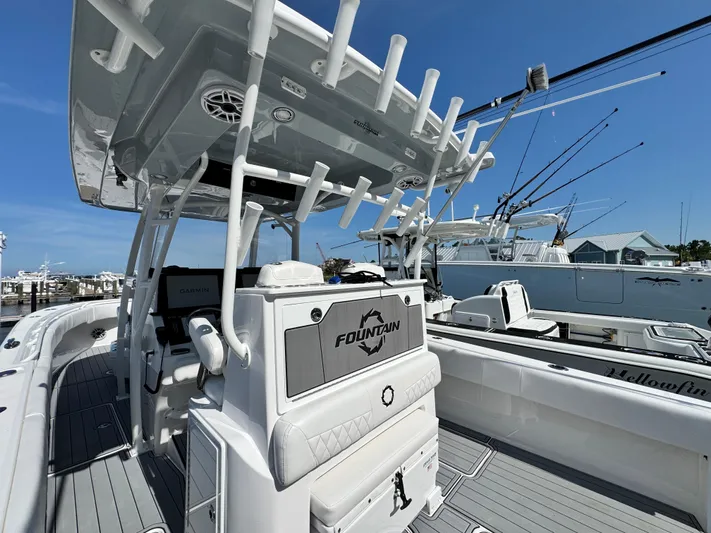  Yacht Photos Pics 2025 Fountain 34 TE boat with advanced fishing equipment and sleek design at a marina.