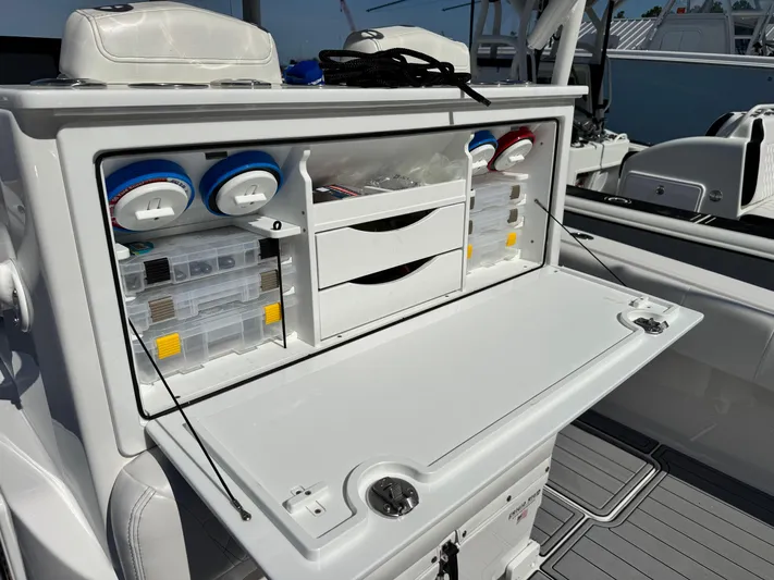  Yacht Photos Pics 2025 Fountain 34 TE boat with open storage compartment and organized fishing gear.