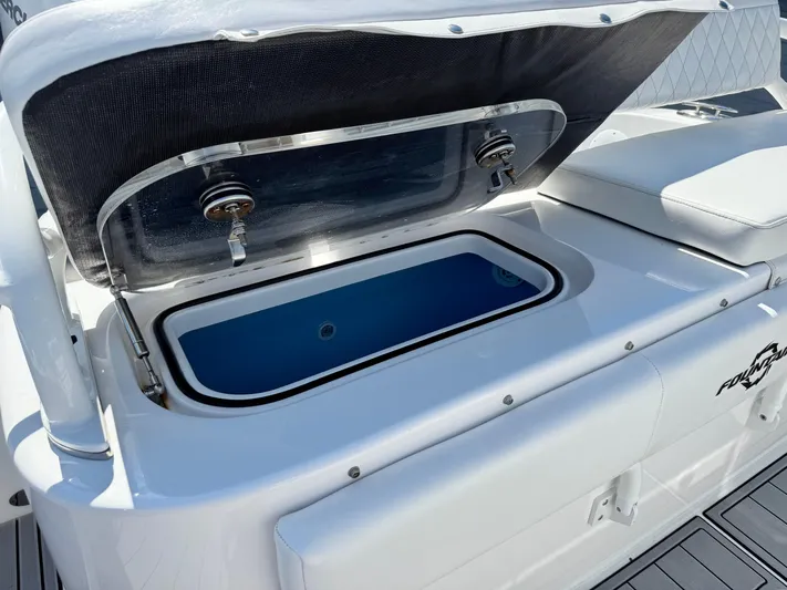  Yacht Photos Pics Open storage compartment on 2025 Fountain 34 TE boat, featuring sleek white design.