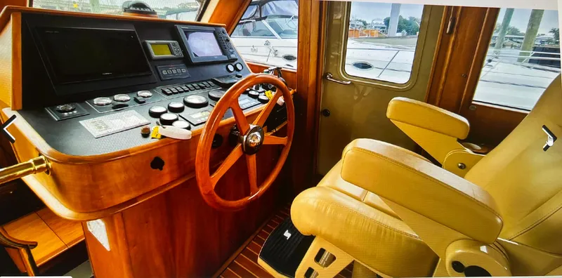 Edmond Dantes Yacht Photos Pics 2004 Legacy Downeast boat interior with wooden steering wheel and control panel.