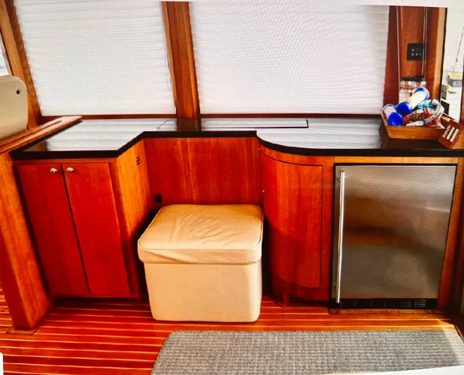 Edmond Dantes Yacht Photos Pics 2004 Legacy Downeast boat interior with wooden cabinetry and mini fridge.