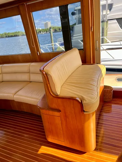 Edmond Dantes Yacht Photos Pics Luxurious 2004 Legacy Downeast yacht interior with leather seating and wooden flooring.