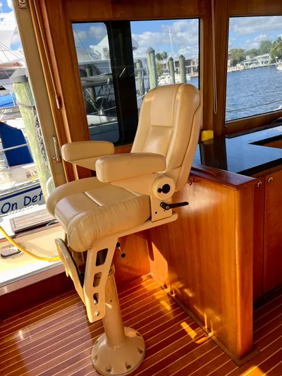 Edmond Dantes Yacht Photos Pics Captain's chair in 2004 Legacy Downeast boat, overlooking marina through large windows.