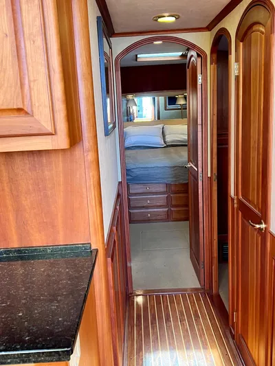 Edmond Dantes Yacht Photos Pics Interior of 2004 Legacy Downeast boat with wooden cabinetry and cozy bedroom.