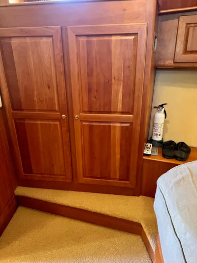 Edmond Dantes Yacht Photos Pics 2004 Legacy Downeast cabin interior with wooden cabinets and fire extinguisher.