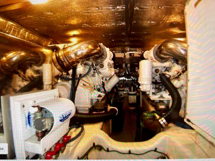 Edmond Dantes Yacht Photos Pics Engine room of a 2004 Legacy Downeast boat with visible machinery and pipes.