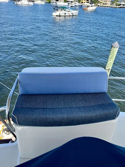 Edmond Dantes Yacht Photos Pics Blue cushioned seat on 2004 Legacy Downeast boat overlooking marina.
