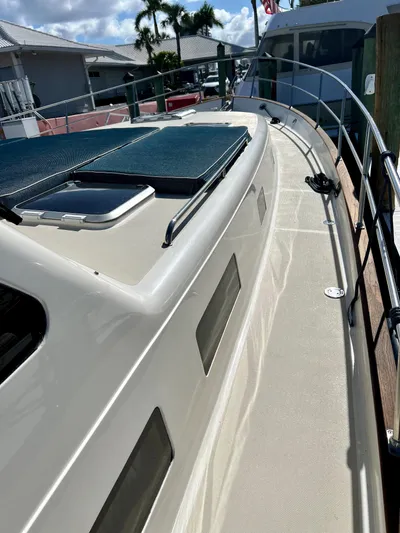 Edmond Dantes Yacht Photos Pics 2004 Legacy Downeast boat deck with railing, docked in marina.