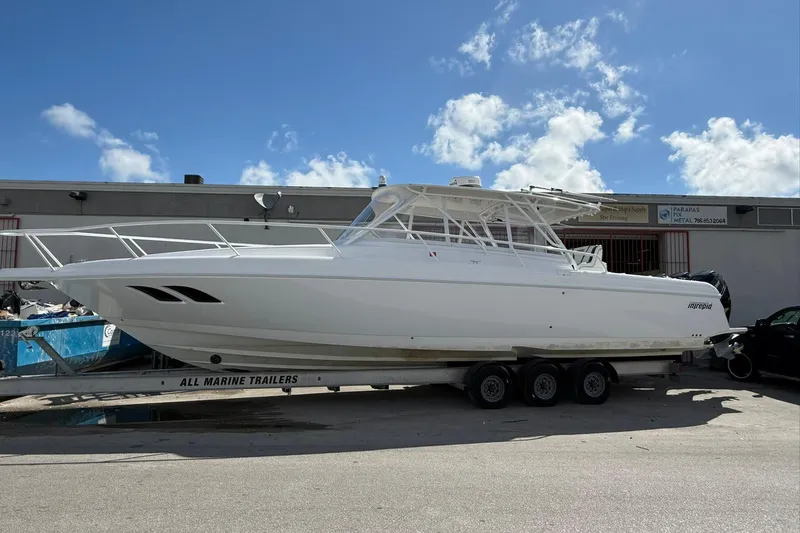  Yacht Photos Pics 2008 Intrepid 390 Sport Yacht on trailer under clear blue sky.