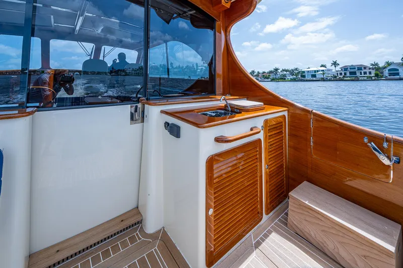  Yacht Photos Pics Hinckley Talaria 43 Motoryacht 2021 interior with wooden cabinetry and waterfront view.