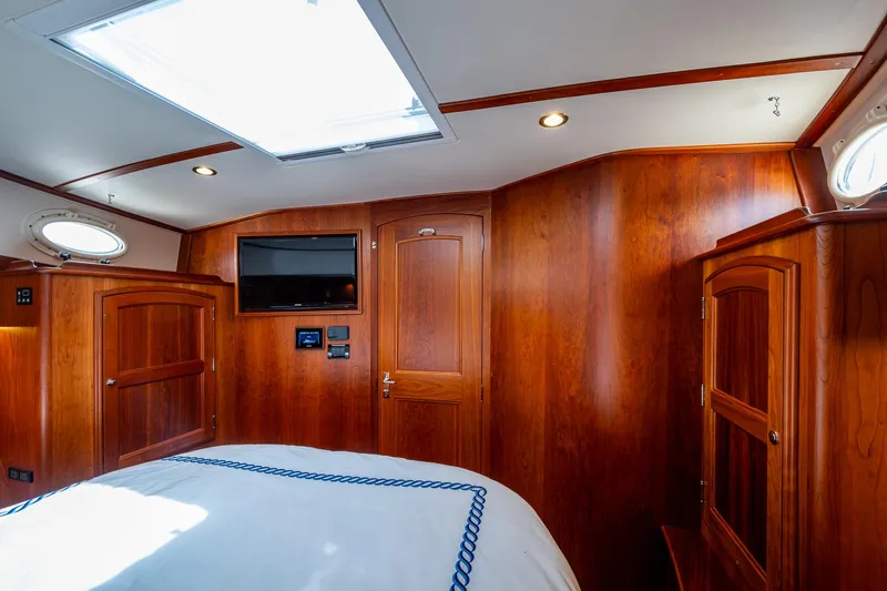  Yacht Photos Pics Luxurious wood interior of 2021 Hinckley Talaria 43 Motoryacht cabin with skylight and TV.