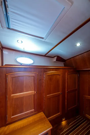 Yacht Photos Pics Interior of 2021 Hinckley Talaria 43 Motoryacht with wooden cabinetry and ceiling lights.