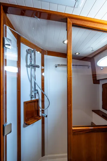  Yacht Photos Pics Luxurious shower in 2021 Hinckley Talaria 43 Motoryacht with wood accents and modern fixtures.