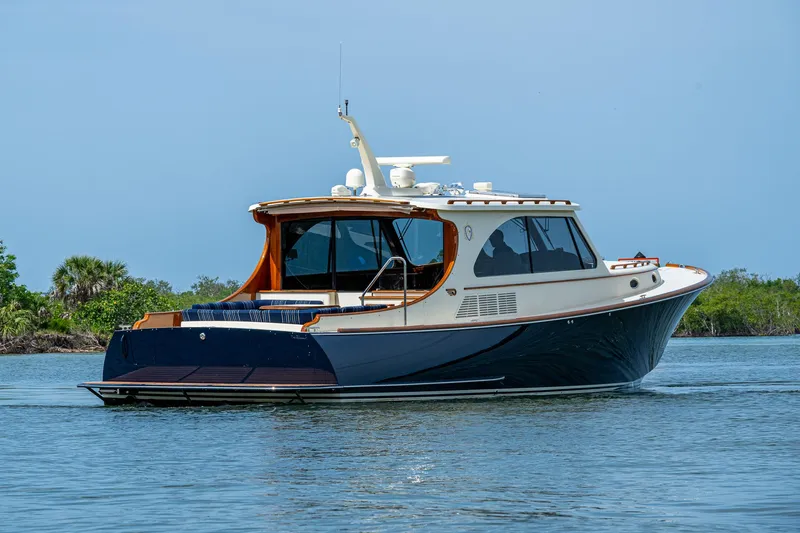  Yacht Photos Pics 2021 Hinckley Talaria 43 Motoryacht cruising on calm waters, showcasing elegant design.