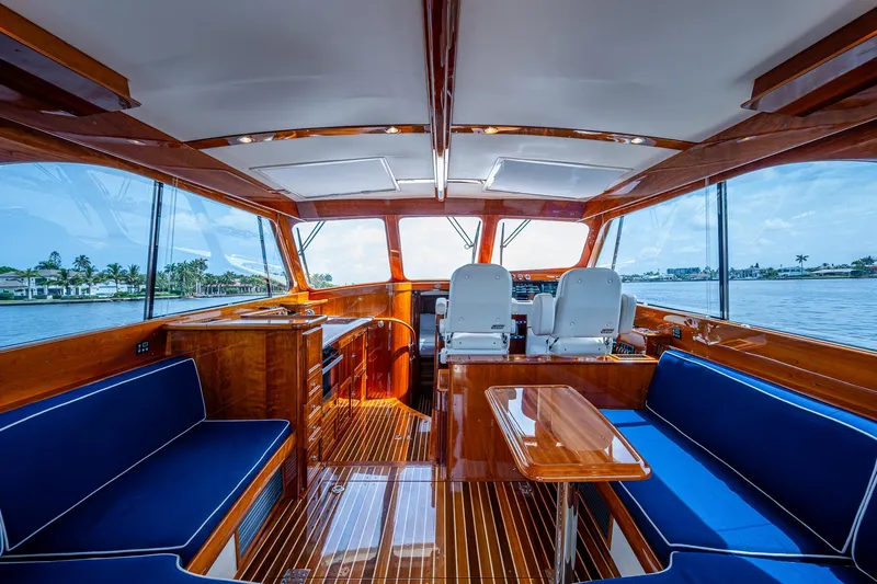  Yacht Photos Pics Luxurious interior of 2021 Hinckley Talaria 43 Motoryacht with elegant wood finish and blue seating.