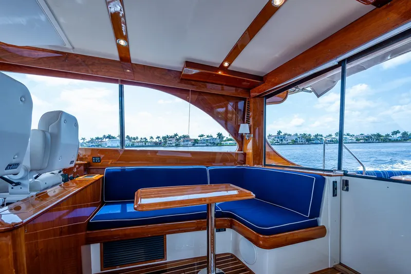  Yacht Photos Pics Luxurious interior of 2021 Hinckley Talaria 43 Motoryacht with blue seating and wooden accents.