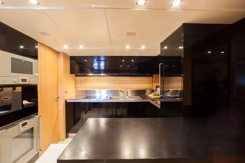  Yacht Photos Pics Luxurious kitchen interior on a 2010 Canados 90 yacht, featuring modern appliances and sleek design.