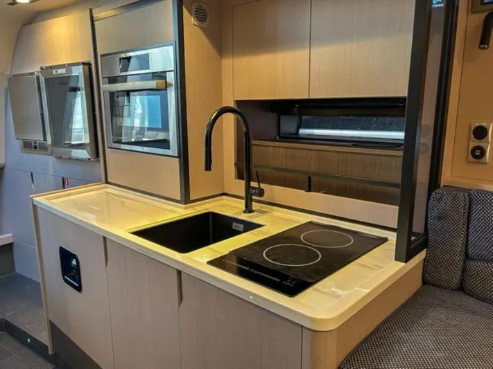  Yacht Photos Pics Modern kitchen in 2024 Windy 40 Camira SX yacht with sleek appliances and induction cooktop.