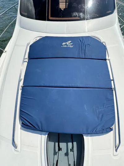  Yacht Photos Pics 2005 Sea Ray 58 Sedan Bridge with blue sunpad on deck.