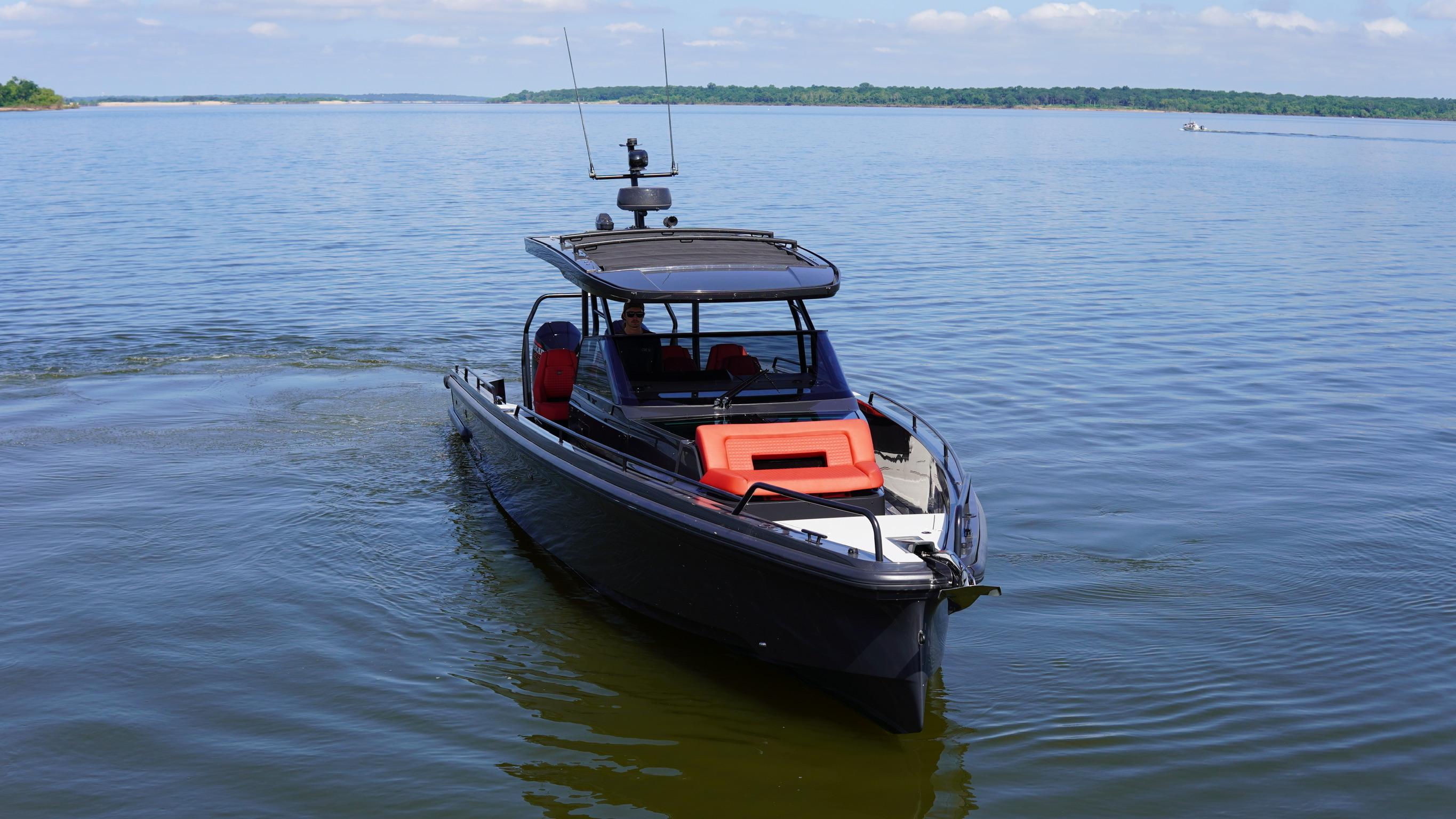 2020 BRABUS Shadow 900 Sun Top boat on calm water, clear sky background.