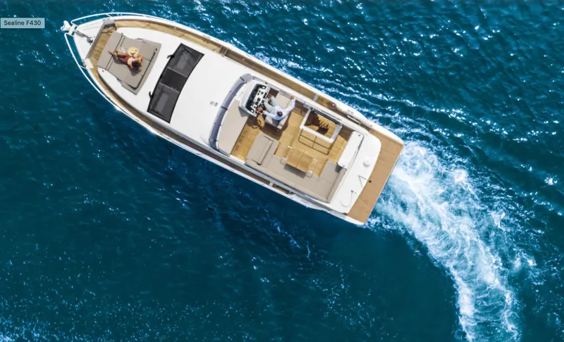  Yacht Photos Pics 2024 Sealine F430 yacht cruising on open blue water, aerial view.