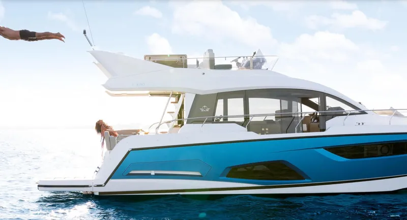  Yacht Photos Pics 2024 Sealine F430 yacht on water, person diving off the side, sunny day.