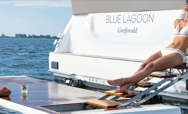  Yacht Photos Pics 2024 Sealine F430 yacht, "Blue Lagoon," with sunbather on deck, ocean backdrop.