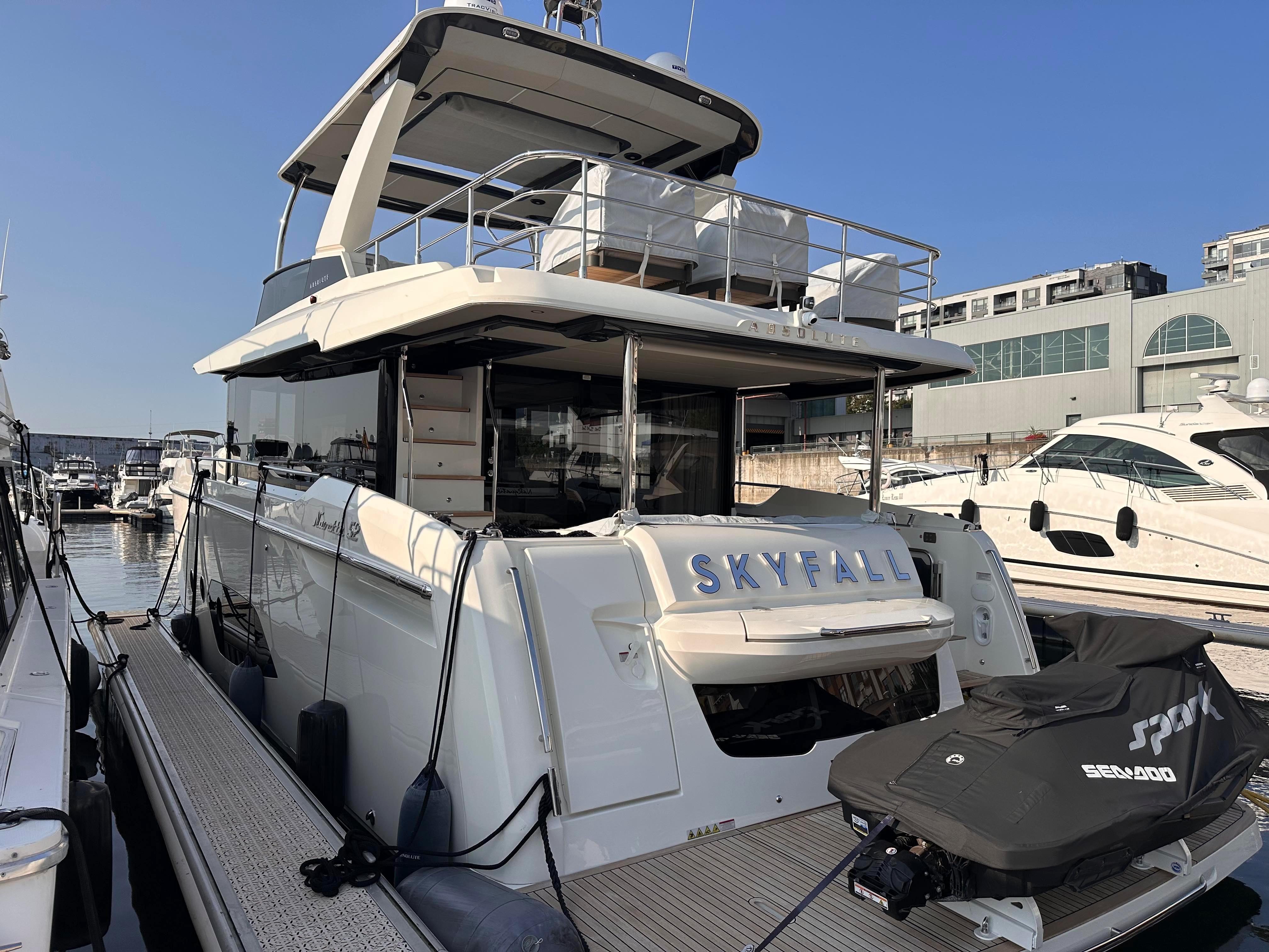 Absolute 52 Navetta Yacht 2022 docked, side view.