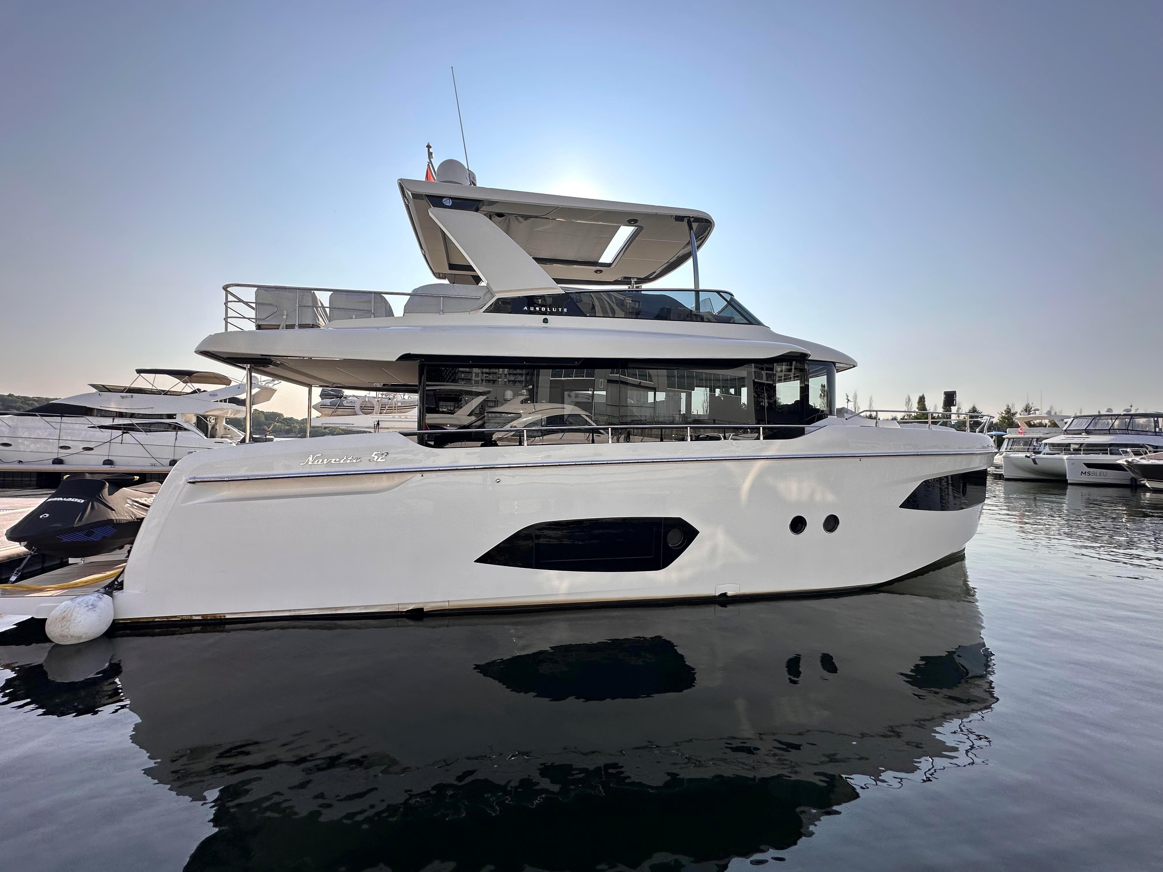 Absolute 52 Navetta 2022 yacht docked, sleek design.