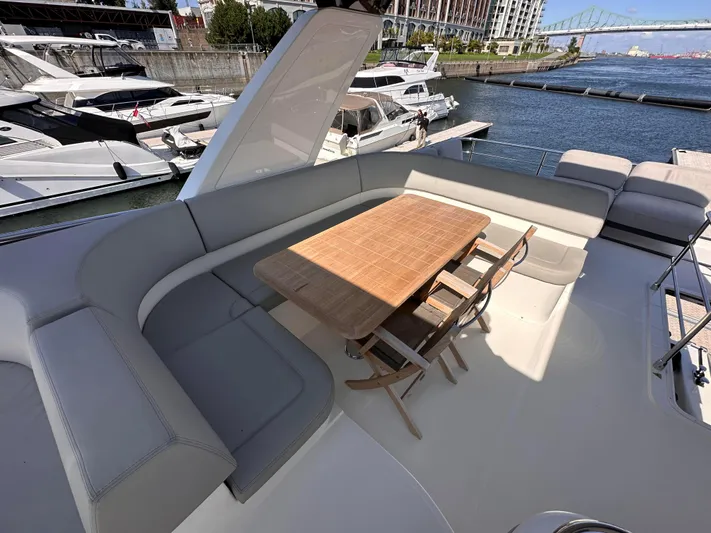 Skyfall Yacht Photos Pics Luxurious deck of Absolute 52 Navetta yacht, 2022 model, featuring dining table and seating area.