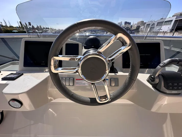 Skyfall Yacht Photos Pics Helm of Absolute 52 Navetta 2022 with modern steering wheel and instruments.