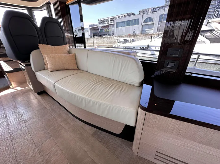 Skyfall Yacht Photos Pics Interior of 2022 Absolute 52 Navetta with elegant leather couch.
