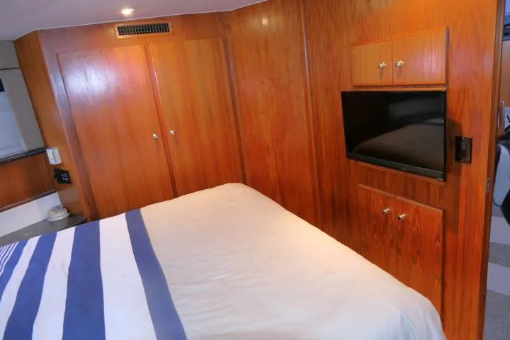 Code Four Yacht Photos Pics Interior of 2000 Carver 406 Motor Yacht with wood paneling and mounted TV.