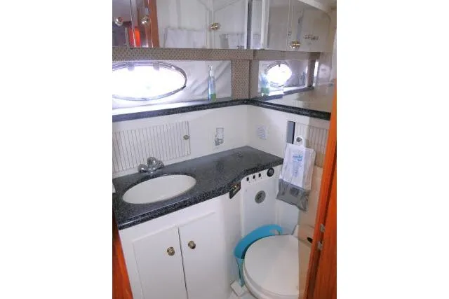 Code Four Yacht Photos Pics Bathroom interior of 2000 Carver 406 Motor Yacht with sink and toilet.