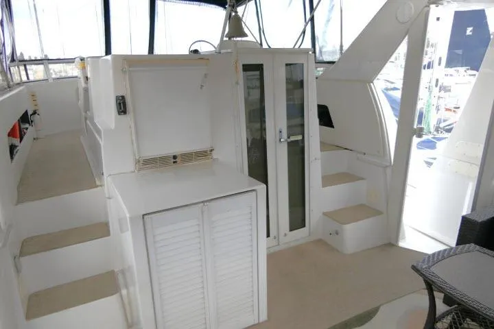 Code Four Yacht Photos Pics Interior of 2000 Carver 406 Motor Yacht with white cabinetry and steps.