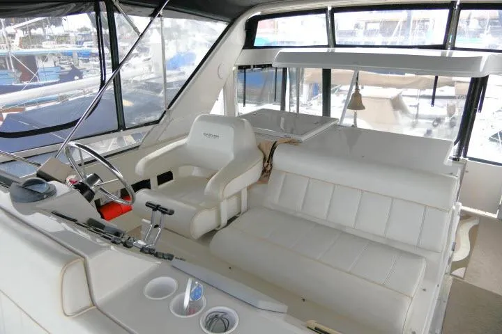 Code Four Yacht Photos Pics Interior of 2000 Carver 406 Motor Yacht with white seating and helm station.