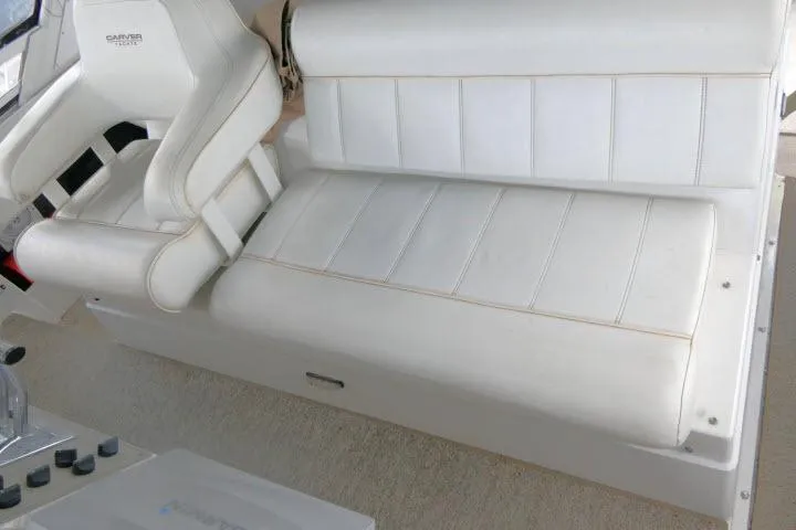 Code Four Yacht Photos Pics White leather seating on 2000 Carver 406 Motor Yacht, featuring helm chair and bench.