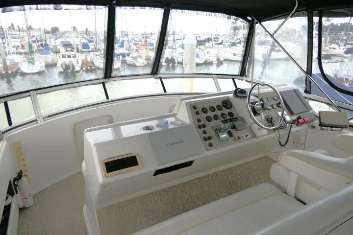 Code Four Yacht Photos Pics Helm of 2000 Carver 406 Motor Yacht with marina view in background.