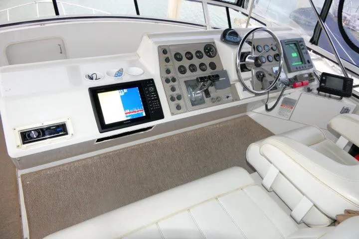 Code Four Yacht Photos Pics 2000 Carver 406 Motor Yacht helm with navigation instruments and steering wheel.
