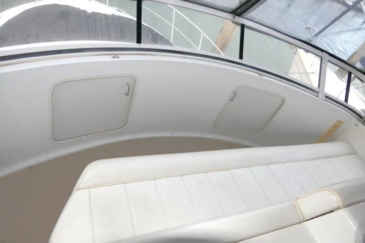 Code Four Yacht Photos Pics 2000 Carver 406 Motor Yacht interior with white seating and storage compartments.