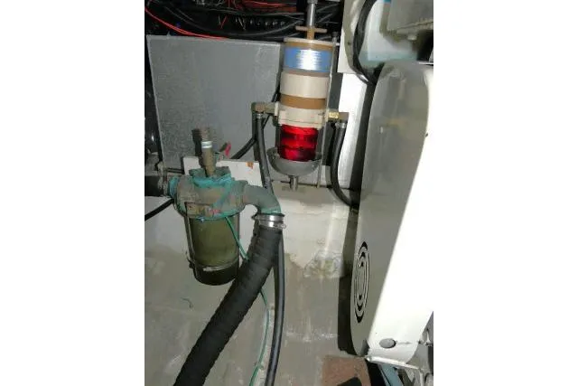 Code Four Yacht Photos Pics Engine room components of 2000 Carver 406 Motor Yacht, featuring filters and hoses.