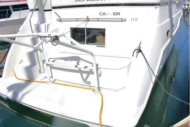 Code Four Yacht Photos Pics Carver 406 Motor Yacht 2000 docked, rear view with visible deck and railing.