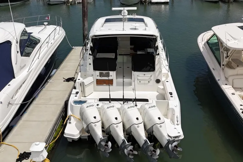  Yacht Photos Pics 2021 Boston Whaler 405 Conquest docked with four powerful outboard engines.