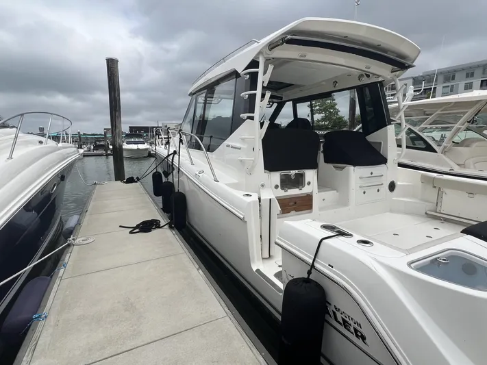  Yacht Photos Pics 2021 Boston Whaler 405 Conquest docked at marina under cloudy skies.