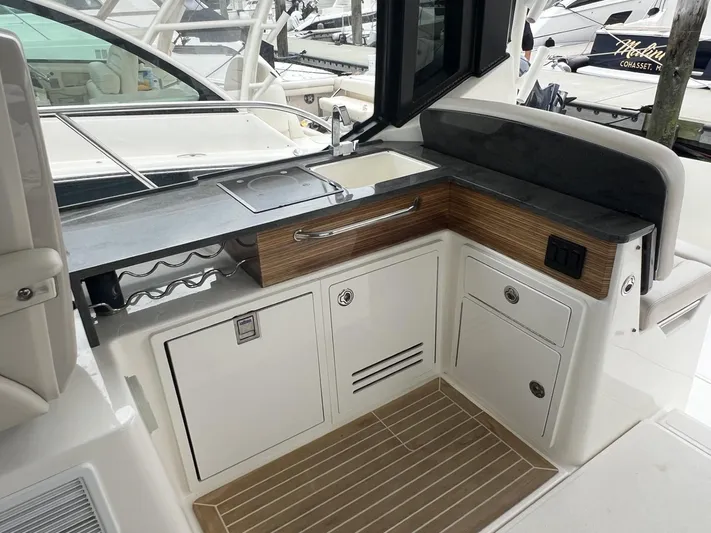  Yacht Photos Pics Boston Whaler 405 Conquest 2021 boat interior with sleek kitchenette and storage cabinets.