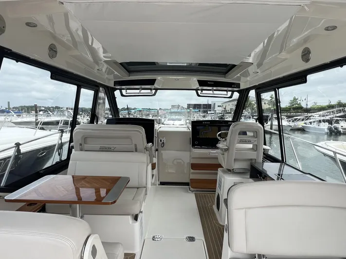  Yacht Photos Pics Interior of 2021 Boston Whaler 405 Conquest yacht, featuring luxurious seating and helm.