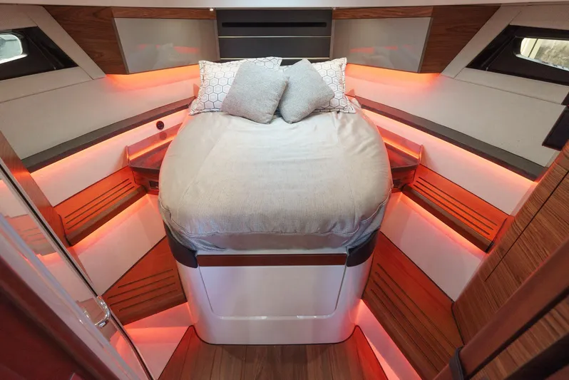  Yacht Photos Pics Luxurious cabin interior of 2021 Boston Whaler 405 Conquest with ambient lighting and cozy bedding.